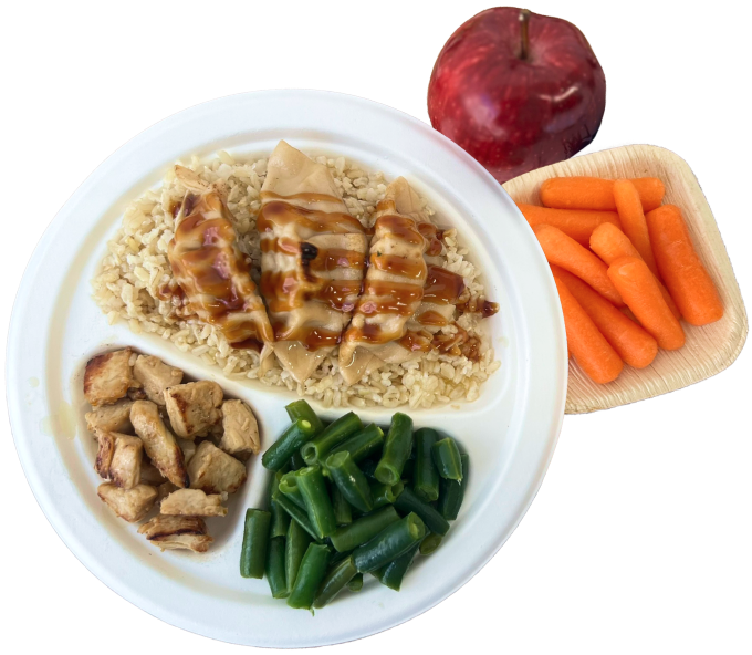 Plate of dumplings with green beans rice chicken carrots and an apple